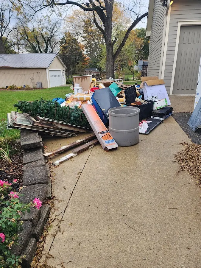 Dumpster being loaded with debris for Estate Cleanout Dumpster Rental in Maple Shade